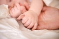 Bed, holding hands and parent with infant, care and support with maternity, health and wellness at home. Fingers, family Royalty Free Stock Photo