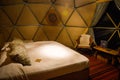 Bed and interior of dome on luxury glamping hotel