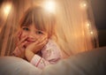 Bed, lights and portrait of child at night for resting, relaxing and dreaming in home. Happy, smile and face of young Royalty Free Stock Photo