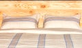 Bed linen, texture of beautiful beige cotton fabric on the background of the headboard made of wood