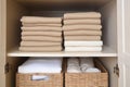 Bed linens closet arrangement on shelves. Minimalist comfortable storage. Generative AI