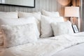 Bed maid-up with clean white pillows and bed sheets in beauty room. Close-up. Lens flair in sunlight. Royalty Free Stock Photo