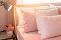 Bed maid-up with clean white pillows and bed sheets in beauty room. Close-up. Lens flair in sunlight. Royalty Free Stock Photo