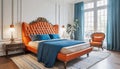 Bed with orange leather headboard and blue bedding. Art deco style interior design of modern bedroom Royalty Free Stock Photo