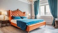 Bed with orange leather headboard and blue bedding. Art deco style interior design of modern bedroom Royalty Free Stock Photo