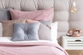 Bed with pastel color pillows Royalty Free Stock Photo