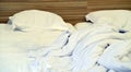 Bed with pillows and crumpled blanket. Crumpled blanket and pillows on empty rumpled bed in hotel room after sleeping in Royalty Free Stock Photo