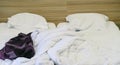 Bed with pillows and crumpled blanket. Crumpled blanket and pillows on empty rumpled bed in hotel room after sleeping in Royalty Free Stock Photo