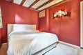 a bedroom with red walls and a white bed Royalty Free Stock Photo