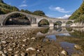 The bed of the Serchio appears almost dry under the ancient Roman bridge of the Maddalena or the Devil, Borgo a Mozzano, Italy Royalty Free Stock Photo