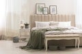 Bed with stylish grey linens near white wall in room Royalty Free Stock Photo