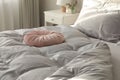 Bed with stylish silky linens in room Royalty Free Stock Photo
