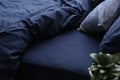 Bed with stylish silky linens in room Royalty Free Stock Photo