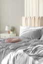 Bed with silky linens in room Royalty Free Stock Photo