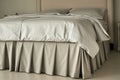 bed with a tailored cashmere bed skirt and highend sheets