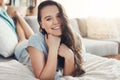 This bed is too comfortable. Portrait of an attractive young woman spending a relaxing day on her bed at home. Royalty Free Stock Photo