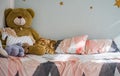 Bed with toys in children`s bedroom