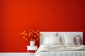 bed with white bedding in the bedroom against a red wall Royalty Free Stock Photo