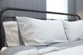 Comfortable white and grey pillow on bed Royalty Free Stock Photo