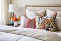 bed with white linens and colorful throw pillows