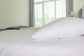 A bed with white sheets and pillows close up at a hotel appartment Royalty Free Stock Photo