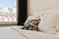 a pillow on a bed in front of a window Royalty Free Stock Photo