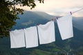 Bedclothes hanging on washing line in mountains