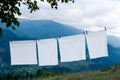 Bedclothes hanging on washing line in mountains