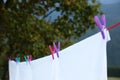 Bedclothes hanging on washing line outdoors, closeup