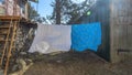 Bedding sheets drying on the clothesline outside. Lens flare. Bed linen drying on a clothes line in the garden. Royalty Free Stock Photo