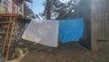 Bedding sheets drying on the clothesline outside. Lens flare. Bed linen drying on a clothes line in the garden. Royalty Free Stock Photo