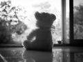 Beddy Bear Sitting with Window in Home Black White Photography,Sybols Baby Gloomy day or International Missing Children,Card Royalty Free Stock Photo