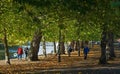 : Trees along Bedford embankment with people walking. Royalty Free Stock Photo