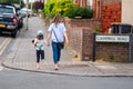 Bedford, Bedfordshire, UK. June 2 2019.Mother and daughter walking down the street