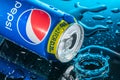 Can of Pepsi, a carbonated soft drink manufactured by PepsiCo with splashes of water on a black background Royalty Free Stock Photo