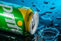 Can of Sprite with splashes of water on a black background and water drops