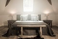 Front view of a rural style bedroom with wooden bench Royalty Free Stock Photo