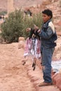 Bedouin boy selling traditional headscarves