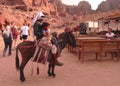 Bedouin on donkey with child in Petra, Jordan