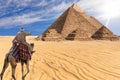 A bedouin of Giza desert in front of the Great Pyramids, Egypt Royalty Free Stock Photo