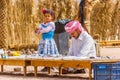 Bedouin and his daughter keep souvenir shop in desert.