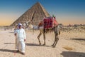 Bedouin man dressed in traditional clothes, in front of the Giza Necropolis pyramids complex. Egypt, Africa