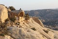 Bedouin man guide sitting on rock formation