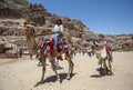 A Bedouin man riding a camel through the ancient site of Petra in Jordan. Royalty Free Stock Photo