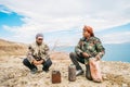 A Bedouin men cook hot tea on sand in the Jordanian valley