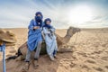 Bedouin men resting on the camel on dunes of Sahara Desert, Africa Royalty Free Stock Photo