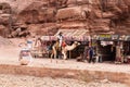 Bedouin rides on camel near souvenir shops in Nabatean Kingdom of Petra in Wadi Musa city in Jordan