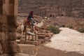 Bedouin riding a Camel in Petra, Jordan Royalty Free Stock Photo