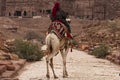 Bedouin riding a Camel in Petra, Jordan Royalty Free Stock Photo