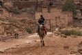 Bedouin riding a Camel in Petra, Jordan Royalty Free Stock Photo